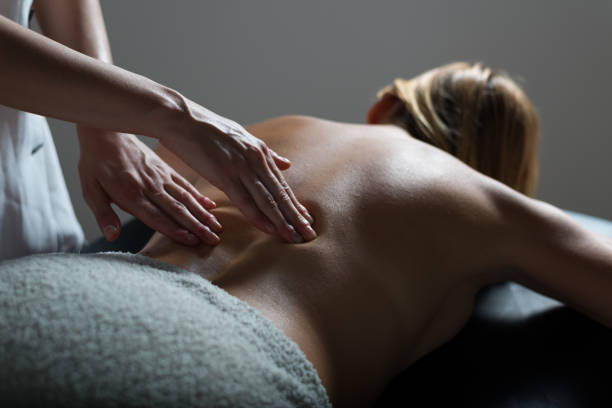 Woman getting massage in health spa stock photo