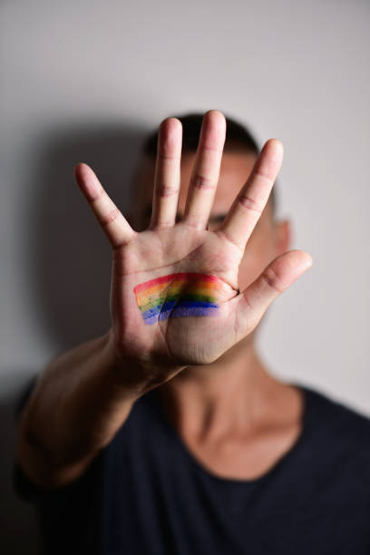 istock man with a rainbow flag in his hand 914833834