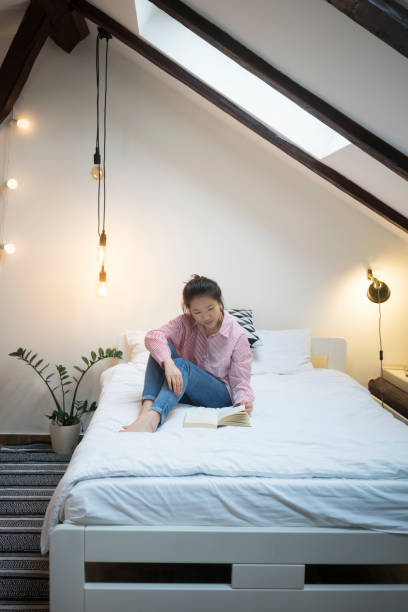 istock Young Chinese woman reading book 914834410
