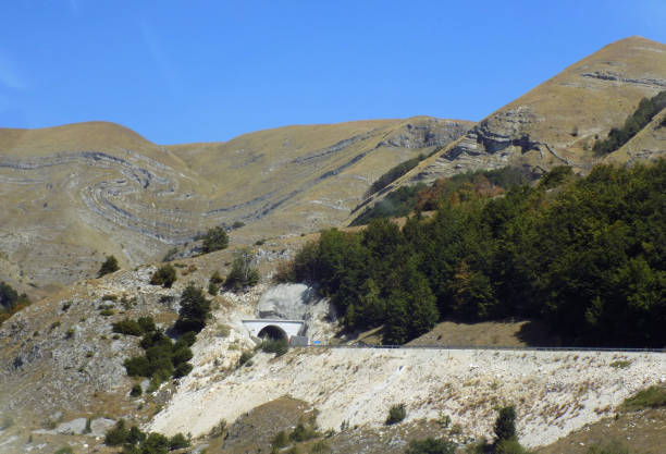 istock drive to the tunnel in the mountains 914835406