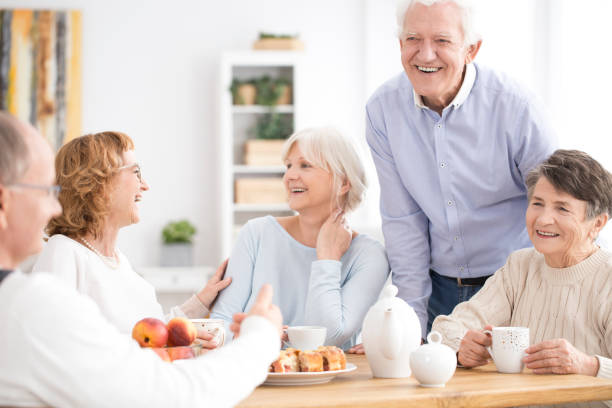 istock Smiling senior people enjoying meeting 914835604