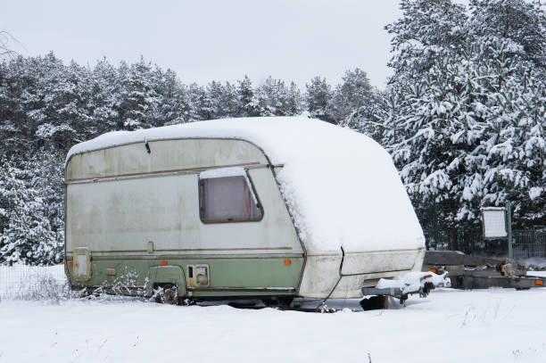 istock Broken tourist car trailer covered  with snow in the winter 914838248