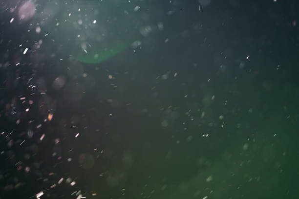 istock real backlit dust particles with green toned flare 914842106
