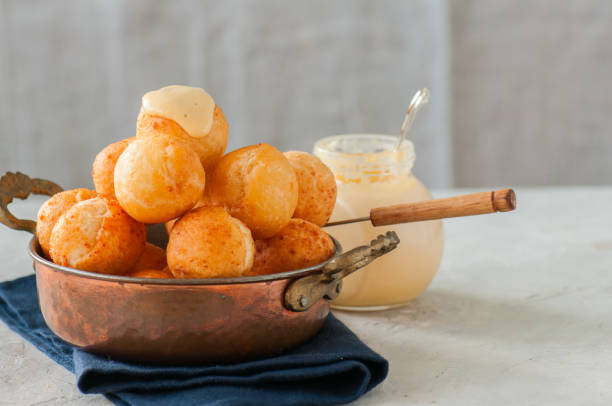 istock Small cottage cheese doughnuts (castgnole) in a bowl. White stone background. 914843538