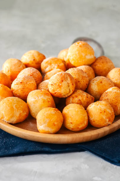 istock Small cottage cheese doughnuts (castgnole) served on a wooden plate. White stone background. 914843564