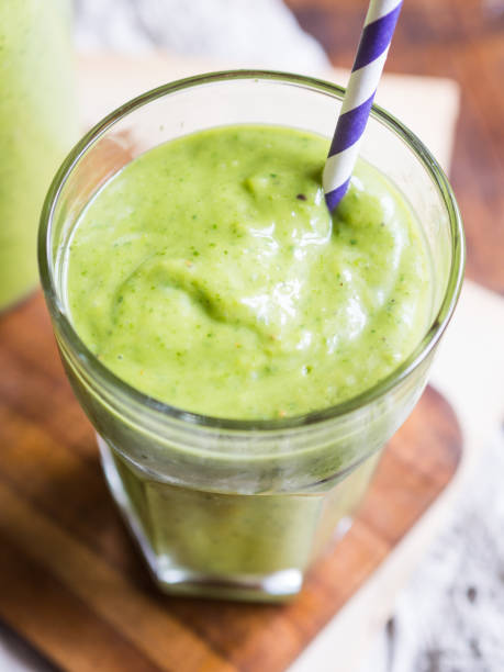 Thick green vegan smoothie in a glass