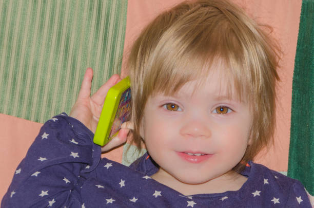 istock baby talking on a toy phone 914846112