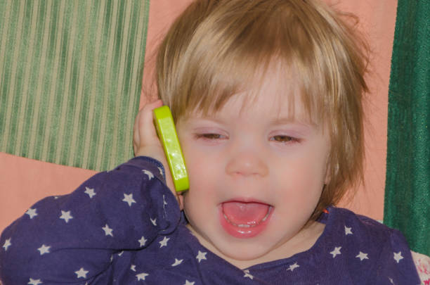 baby talking on a toy phone