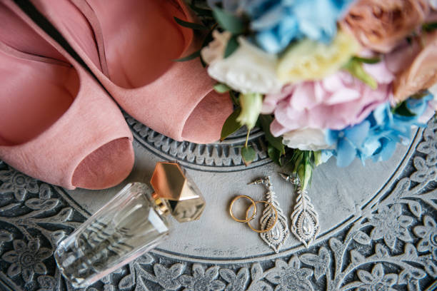 istock Wedding accessories, earrings, perfume, bouquet and pink shoes 914852642