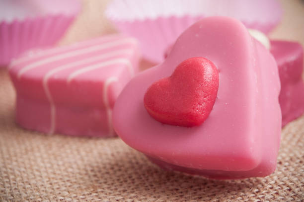 istock pink shaped heart pastry on hessian texture  background for valentines day 914855494