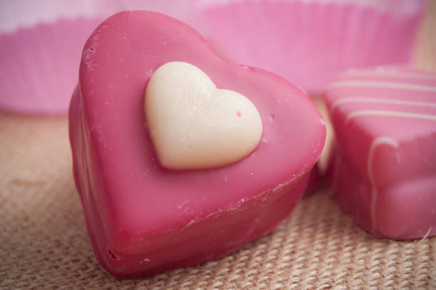 istock pink shaped heart pastry on hessian texture  background for valentines day 914855496
