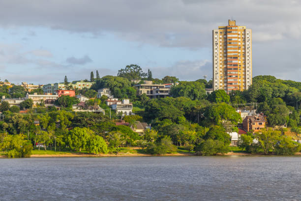 istock Guaiba lake beach with buildings and trees 914855536