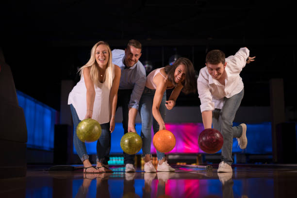 istock Bowling - happy young adults enjoying bowling together 914856140