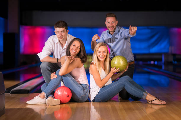 istock Bowling - happy young people in good mood in bowling hall 914856204