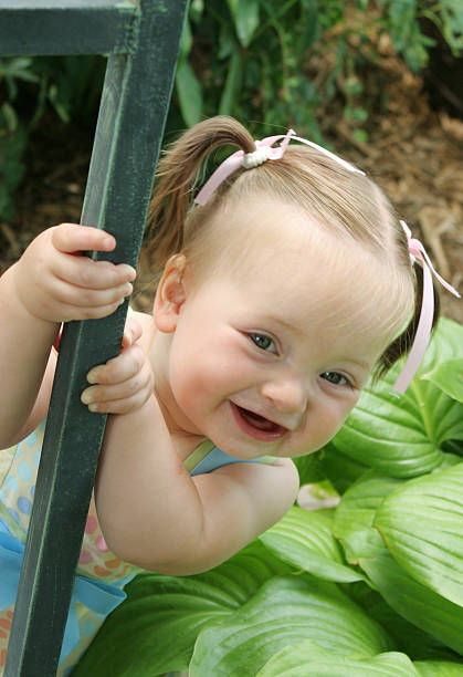 istock Little girl peeking around a corner 91485749