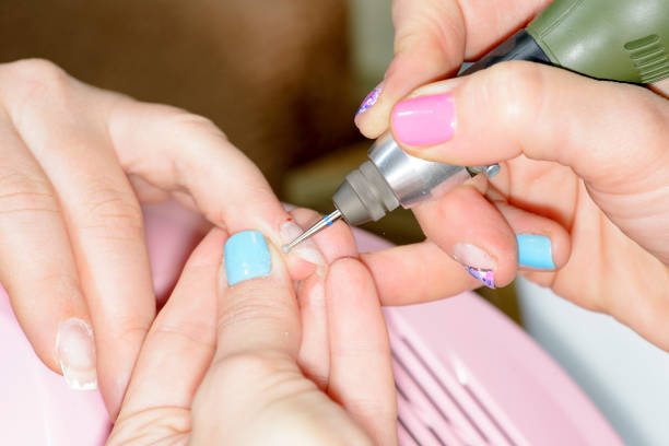 istock manicure master cuts the cuticle on the client's arm 914860202