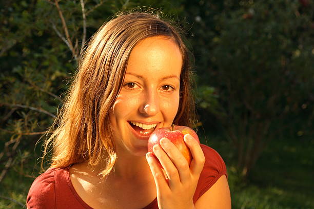 istock Beautiful women eating a red apple 91486910