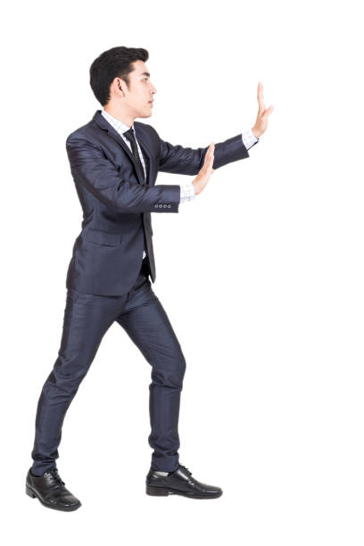 istock Businessman pushing something isolated on white background 914871040