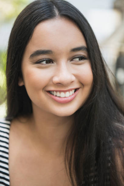 istock Attractive young woman looking away smiling 914875238