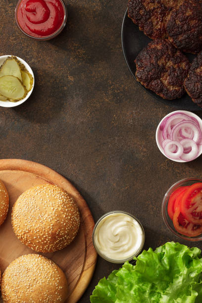 istock Homemade burgers ingredient on the rusty background. 914876980