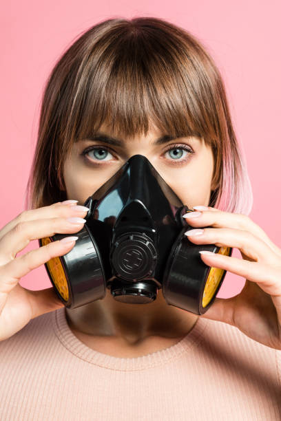 istock young woman wearing respirator 914882786