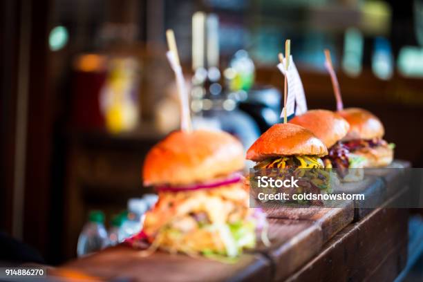 Close Up Of Fresh Flame Grilled Burgers Displayed In A Row At Food Market Stock Photo - Download Image Now