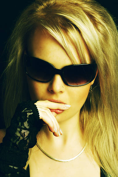 istock Blond girl biting her finger - cross processed 91488634