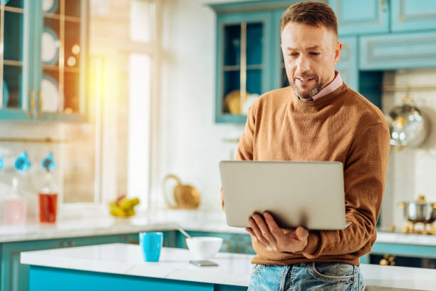 istock Nice handsome man holding his laptop 914888130