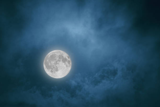istock Full moon in the night sky shining through the clouds 914891504