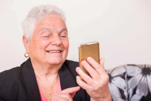 istock Happy senior woman uses smart phone to send text 914892500