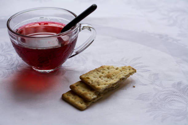 istock Hibiscus tea on white tablecloth against window 914895890