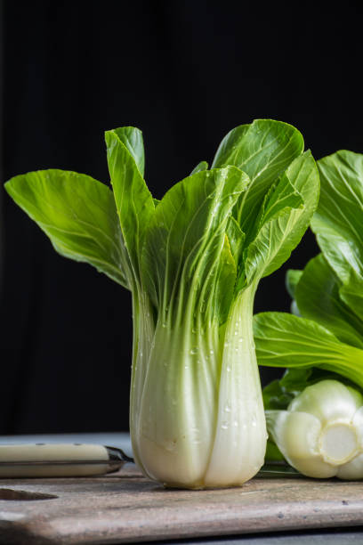 Fresh raw baby Bok choy or pak choi Chinese cabbage Fresh raw green baby Bok choy or pak choi Chinese cabbage rosa chinensis stock pictures, royalty-free photos & images