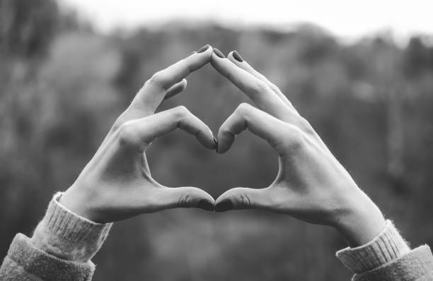 istock Tender girl's pale hands forming a heart shape gesture 914900222