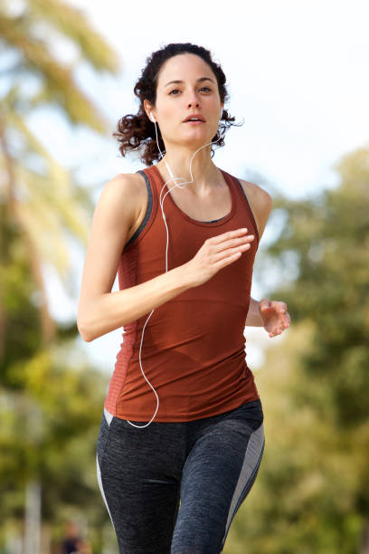 istock young woman running outside in park 914901436