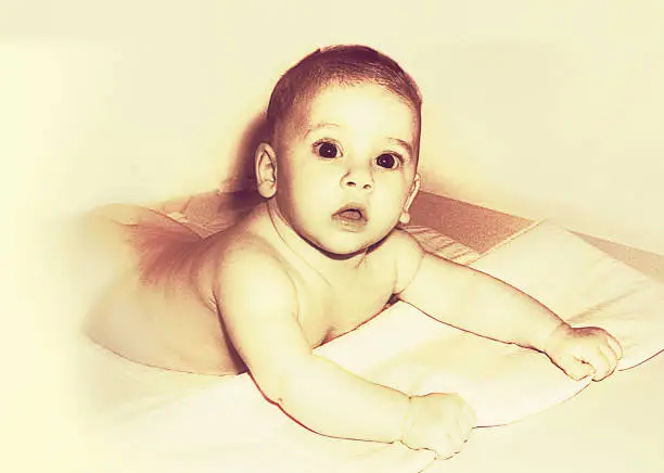 Photo of Sepia toned baby looking at camera