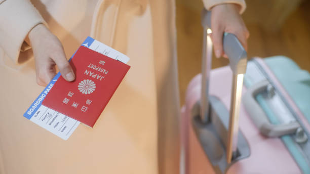 Girl holds Japan passport and boarding pass stock photo