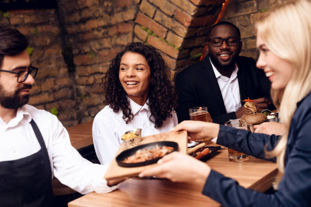 istock Bearded barman brought customers beer and snacks. 914914654
