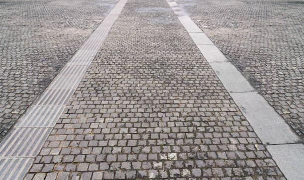 istock Grunge gray brick marble stone on ground road / stone pavement in perspective view, Texture and Background 914918670