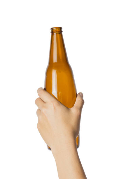 istock Woman's hand holding empty beer bottle transparent on white background, File contains a clipping path. 914921136