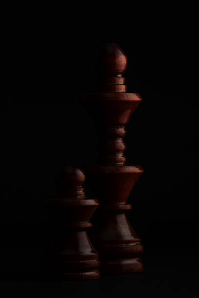 istock Chess. Black Pawn and Queen on black background. 914926198