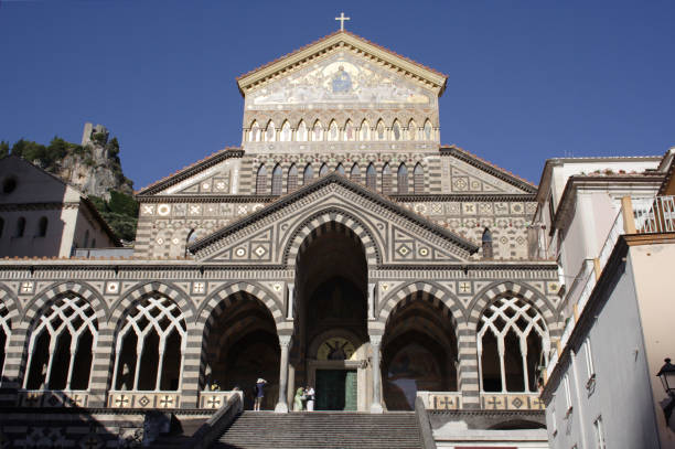 Low angle view of the entrance and the facade of Amalfi Cathedral dedicated to the Apostle Saint Andrew at Amalfi city, Italy.