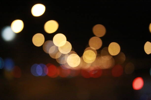 istock Light bokeh and traffic at nighttime abstract background 914929356