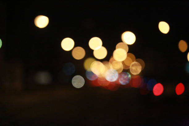 istock Light bokeh and traffic at nighttime abstract background 914929358
