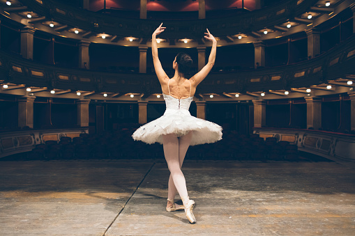 Black teenager girl dancing neo-classic ballet on stage