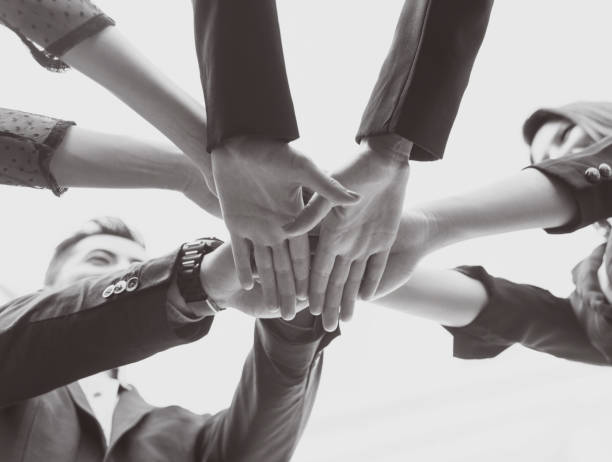 istock young people putting their hands together. concept teamwork and unity. 914932318