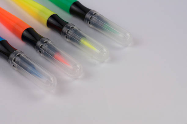 istock Row of colored marker brushes with transparent plastic tip on  white school desk with copy space 914933328