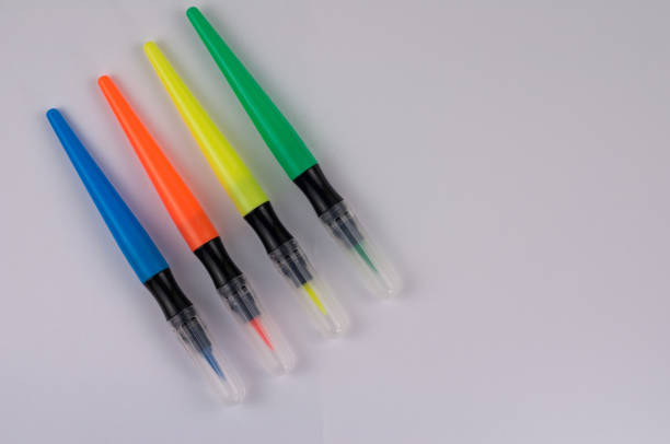 istock Row of colored marker brushes with transparent plastic tip on  white office table with copy space 914933356