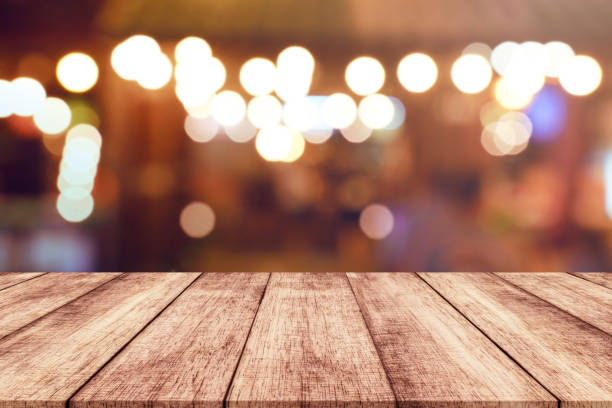 istock Wood table top with blurred light bokeh abstract background 914933434