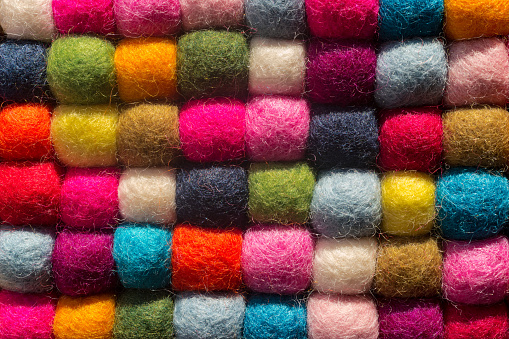 Felting background: top view of multicolored woolen balls