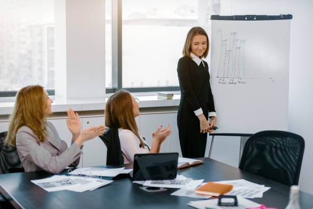 istock girl in office shows graphics as the marker board 914936576